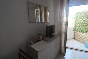 a living room with a tv on a wall at sognandocasab&b tortora in Praia a Mare