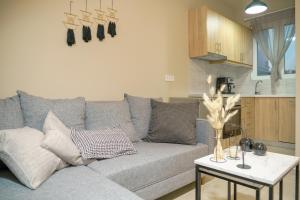 a living room with a gray couch and a table at RODOU Suites & Villas in Chania Town