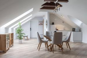 a kitchen and dining room with a table and chairs at KONTRAKT Boutique Hotel in Kyiv