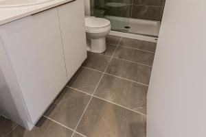 a bathroom with a toilet and a sink at Modern and New Studio in the Heart of the City by Den Stays in Montréal +8 photos
