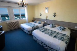 Postel nebo postele na pokoji v ubytování Hotel De La Mer