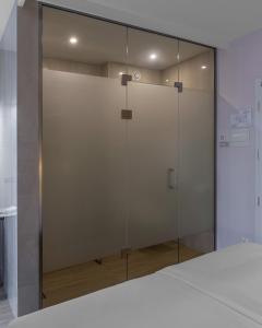 a glass shower door in a room at KONTRAKT Boutique Hotel in Kyiv