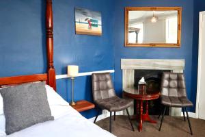 a bedroom with a bed and a table and chairs at Colson House in Brighton & Hove