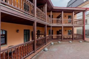 a building with wooden balconies and a patio at KONTRAKT Boutique Hotel in Kyiv