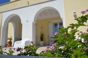 a patio with flowers in front of a house at CàSolare Country House in Sperlonga