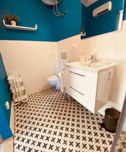 a bathroom with a white sink and a toilet at BOUTIQUE ROOMS Mare Fabulas in Rovinj