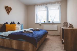 A bed or beds in a room at Apartmán Zara