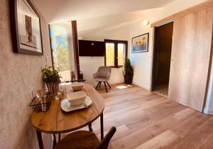 a living room with a wooden table and chairs at BOUTIQUE ROOMS Mare Fabulas in Rovinj