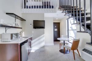 a kitchen and living room with a spiral staircase at Sojourn at DuPont Place in Washington, D.C.