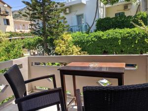 a table and two chairs on a balcony with a table at Pension Irene in Sougia