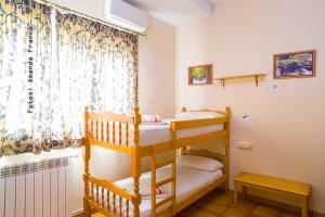 two bunk beds in a room with a window at Albergue de Peregrinos Ultreia et Suseia in Sigüeiro