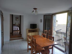 a dining room with a wooden table and chairs at Apartamento Miguel Torla Ordesa in Torla