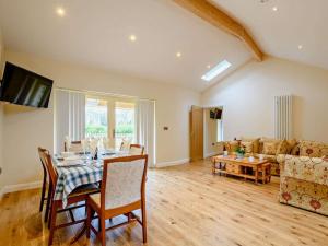 a living room with a table and a couch at The White Lady in Worstead
