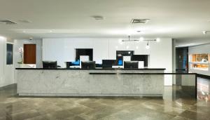 a lobby with a counter with chairs in a room at Hotel Senac Ilha do Boi in Vitória