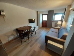 a living room with a couch and a table at Matterhorn Studio Cervinia in Breuil-Cervinia