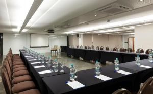 a conference room with tables with bottles of water on them at Hotel Senac Ilha do Boi in Vitória