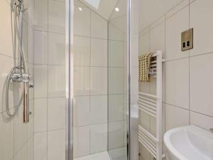a white bathroom with a shower and a sink at The White Lady in Worstead +127 photos
