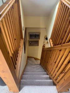 a staircase with wooden railings in a house at Abbey Cottage, Findhorn in Findhorn