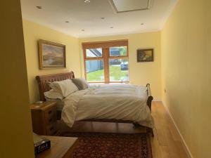 a bedroom with a bed and a window at Abbey Cottage, Findhorn in Findhorn