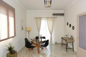 a dining room with a table and black chairs at Alion House in Rhodes Town