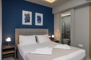 a bedroom with a bed with two towels on it at MIRMA CITY Old Town in Chania