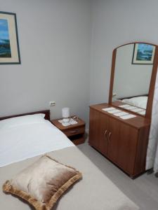a bedroom with a bed and a large mirror at Apartmani Ivana in Novalja