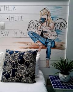 a mural of a fairy sitting on a bench at Forget me not Selfcatering Apartments in Nelspruit