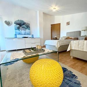 a living room with a bed and a glass table at Dalmatian village charm - spacious villa with pool near Trogir in Primorski Dolac +41 photos