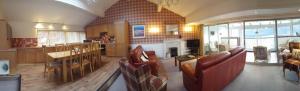 a large kitchen and living room with a table and chairs at Loch Rannoch Highland Lodge 44 in Kinloch Rannoch