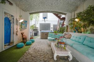 a living room with a blue couch and a table at LE GITE DES TONTONS Maison de charme avec spa privé chauffé toute l'année in Saint-Laurent-de-la-Salanque