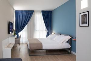 A bed or beds in a room at Alma Suites