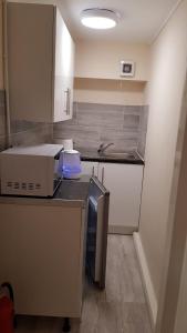 a kitchen with a counter with a box on it at Summerhill House Apartments in Elswick