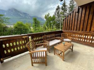 a balcony with chairs and a table with a view at Castle Residence apt. Zamorei in Buşteni