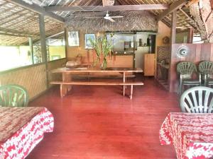 法赫的住宿－HUAHINE - Bungalow Pitate，一间带木桌和椅子的用餐室