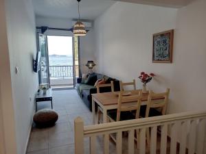 a living room with a table and a couch at PS HOUSE Old Port - PS Rental in Skiathos