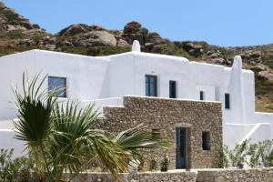a white house on the side of a hill at Archon Seaside Retreat in Plaka