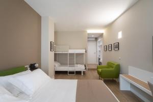 A bed or beds in a room at Alma Suites