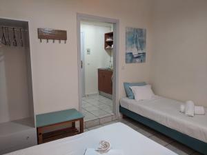a living room with two beds and a hallway at Pension Irene in Sougia