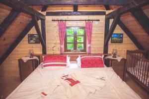 a bedroom with a large bed in a attic at Kuća za odmor Poljanica Okićka in Jastrebarsko