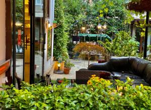 a view of a garden with a couch and some plants at Elea Old Tbilisi Hotel in Tbilisi City