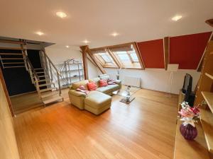 a living room with a couch and a television at Žatecká 4 - Terrace Residence in the Old Town in Prague