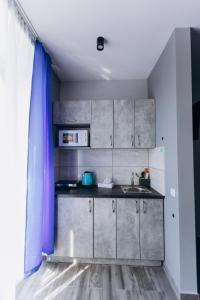 a kitchen with a sink and a counter top at Premium apartment (із панорамним видом на центр міста) in Ivano-Frankivsʼk