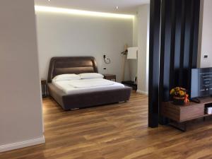 a bedroom with a bed and a flat screen tv at Skanderbeg Apartments 3 in Tirana