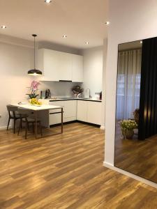 a kitchen and dining room with a table and a dining room at Skanderbeg Apartments 3 in Tirana