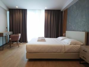 a bedroom with a bed and a desk and a chair at Hotel Byron in Lerici