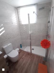 a bathroom with a toilet and a shower and a tub at Los Nidos Sea Pretty&Beach- La Carihuela in Torremolinos