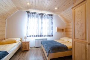 Łóżko lub łóżka w pokoju w obiekcie DW KINGA & DOMKI na Granicznej z jacuzzi