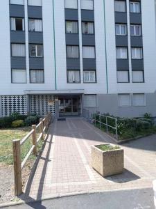 a large building with a fence in front of it at Appartement de 2 chambres avec vue sur la ville et wifi a Clermont Ferrand in Clermont-Ferrand