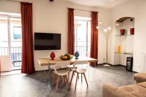 a kitchen and living room with a table and chairs at Casta Diva Luxury Apartments -Self check-in in Palermo