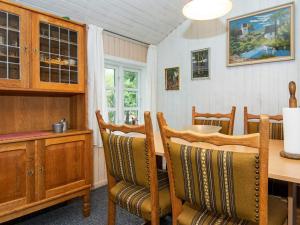 a dining room with a wooden table and chairs at 4 person holiday home in Hemmet in Hemmet